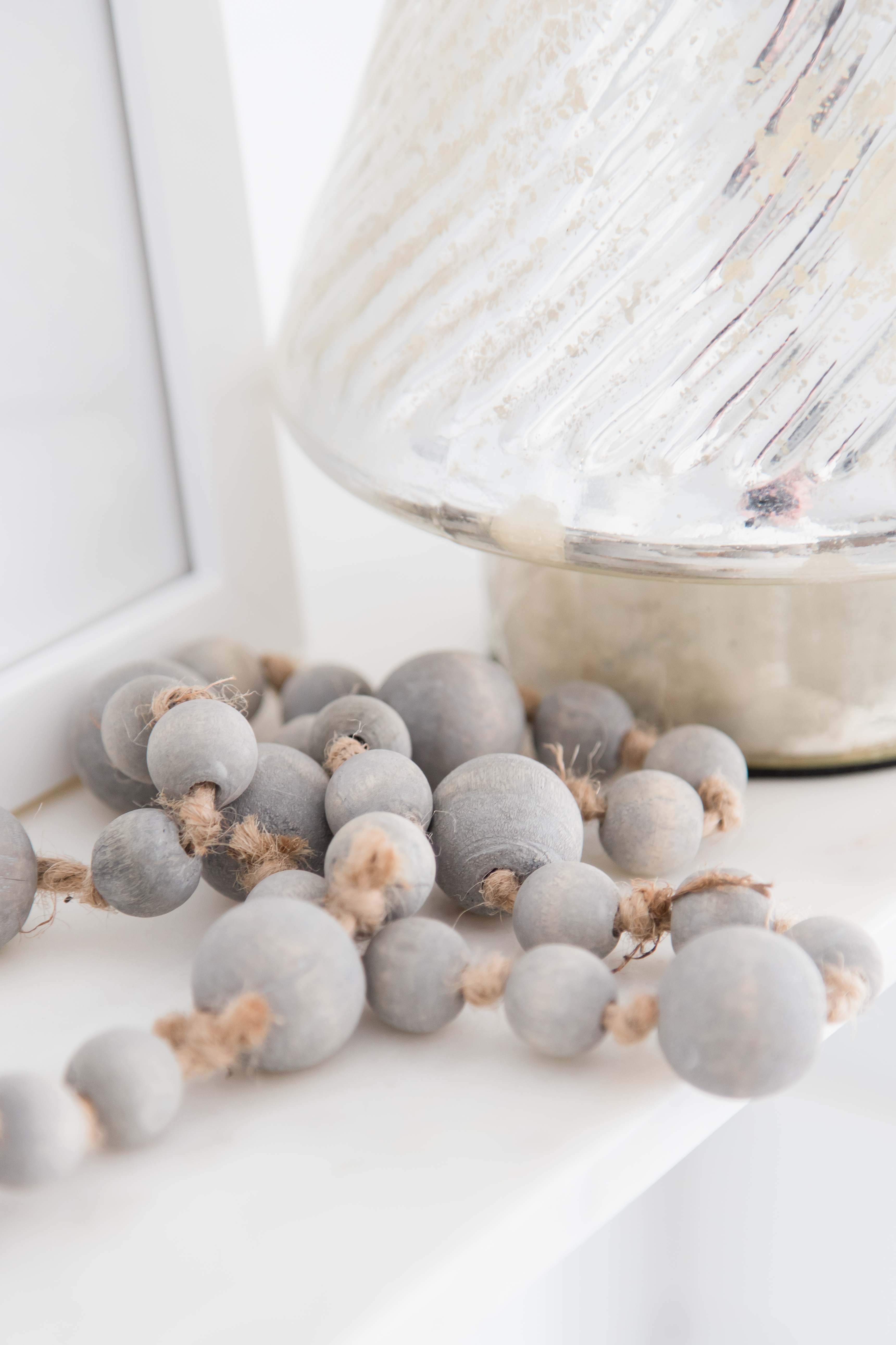 Gray wood beads | AE Home Style Life | Love the texture these beads add to kitchen decor. #graybeads #woodbeads #kitchendecor #whitekitchendecor #shelfdecor #graykitchen
